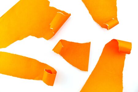 Torn orange paper isolated on white backgroundの写真素材