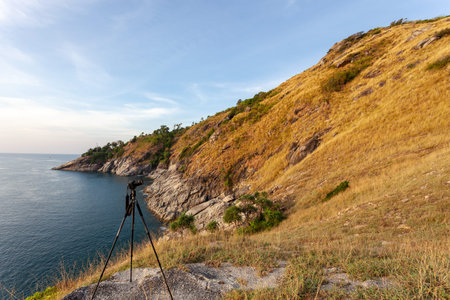 Dry grass on the mountain with seashore blue sky background