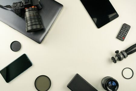 Digital camera with lenses and equipment of the professional photographer on white leather backgroundの写真素材