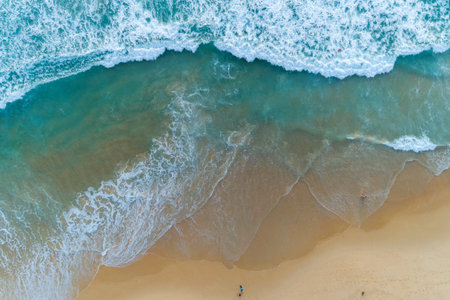 Aerial view sandy beach and crashing waves on sandy shore Beautiful tropical sea in the morning...