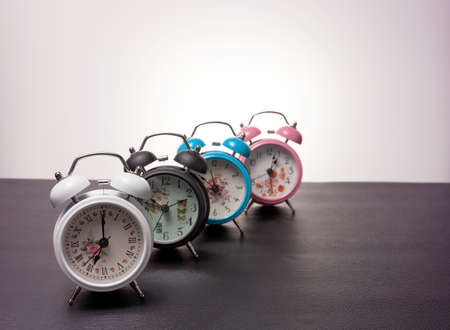 Set of beautiful new alarm clock on black leatherの写真素材