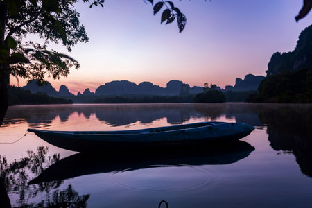 Morning sunrise scenery with boat in the lake at ban nong thale krabi province thailand