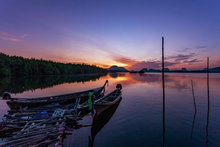 Longtail boats with coastal fishing village ,Beautiful scenery morning sunrise over sea and mountain...