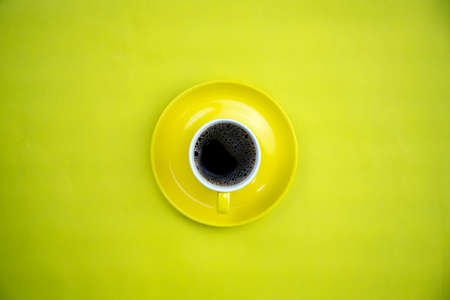Colorful coffee cup on yellow paper backgroundの写真素材