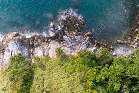 High angle view Tropical sea with wave crashing on seashore and high mountain located in Phuket Thailand aerial view drone top down Amazing nature view.の写真素材