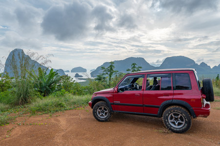19 November 2020 Red 4x4 car Suzuki Vitara 1993 on the High mountain view Beautiful sea view at sunrise in Phangnga Thailand.のeditorial素材