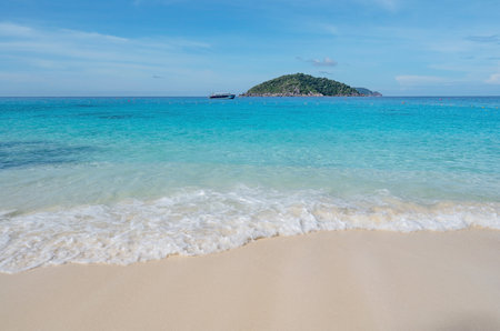 Beautiful beach and tropical sea with wave crashing on sandy shore Small island archipelago at Similan national park Thailand travel and tour concept.の写真素材