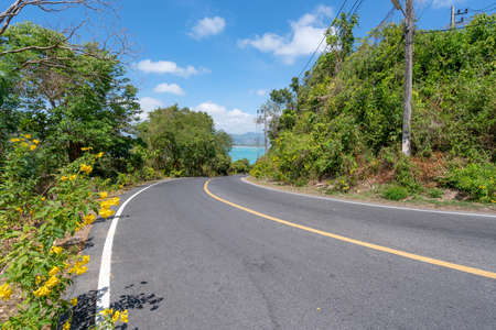 The asphalt road around the phuket island in Summer season beautiful blue sky background at Phuket Thailand.の写真素材