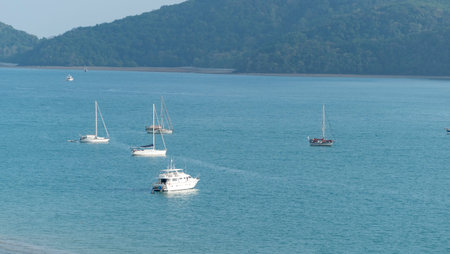 Sailboat or Travel boats in the sea at sunset light with beautiful big mountains background.Luxury...