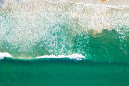 Aerial view Detail of big wave texture in Tropical sea with wave crashing on beach aerial view drone...