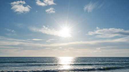 Realistic sun nature view Summer sunny day The horizon of the sea ocean with beautiful sun light flare over sea.の写真素材