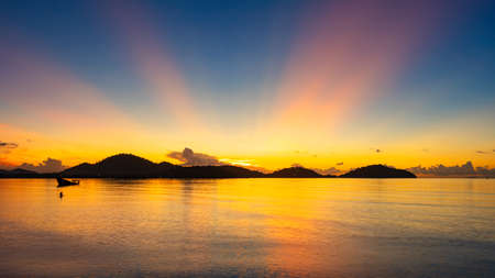 Majestic sunset or sunrise landscape Amazing light of nature cloudscape sky and Clouds moving away rolling colorful dark sunset clouds with reflection in water sea surface Amazing view seascape.の写真素材