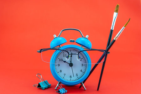 Concept Education or business Alarm clock and teacher glasses Business objects isolated on colorful...