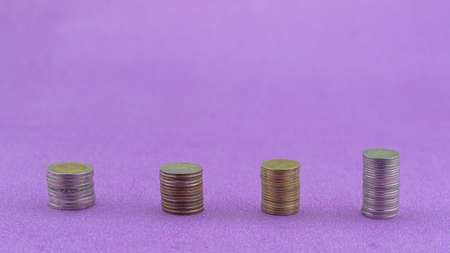 Row of coins thai baht isolated on purple paper backgroundの写真素材