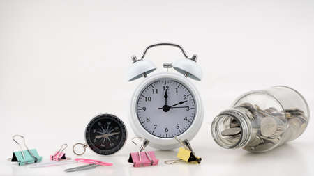 Concept Business finance and Shopping sale Coins in jar with White alarm clock Business objects isolated on white backgroundの写真素材