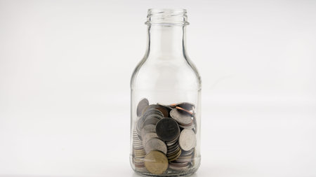 Concept Business finance and Shopping sale Coins in jar with White alarm clock Business objects...