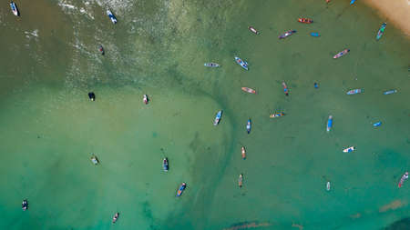 Top down Aerial view drone camera of Beautiful turquoise clear water sea with long tail fishing boats in summer sea Tropical Phuket island of Southern Thailand Amazing seascape Bird eye view.の写真素材