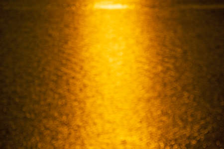 Beautiful gold abstract background with bokeh defocused lights abstract background Beautiful golden light blurred texture background.の写真素材