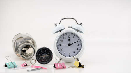 Concept Business finance and Shopping sale Coins in jar with White alarm clock Business objects isolated on white backgroundの写真素材