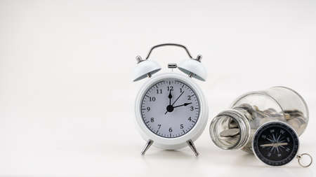 Concept Business finance and Shopping sale Coins in jar with White alarm clock Business objects isolated on white backgroundの写真素材