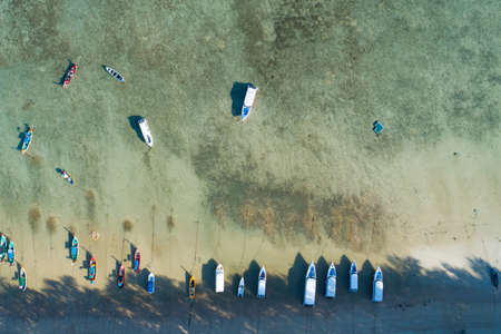 Aerial view top down of Thai traditional longtail fishing boats in the tropical sea beautiful beach in phuket thailand.の写真素材