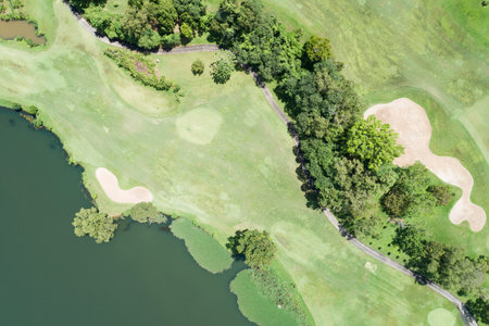 Aerial view drone shot of beautiful green golf field fairway and putting green Top down image for sport background and travel nature background Amazing view at Phuket Thailand.の写真素材