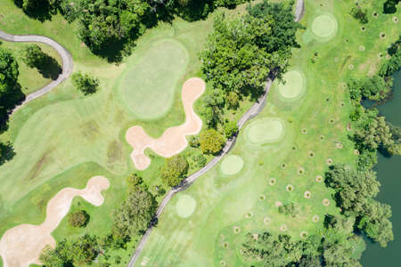 Aerial view drone shot of beautiful green golf field fairway and putting green Top down image for sport background and travel nature background Amazing view at Phuket Thailand.の写真素材