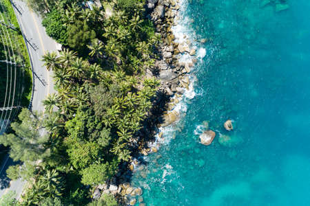 Aerial view of curve road along the seashore at Phuket Thailand beautiful seacoast and open sea in summer season Nature recovered Environment and Travel background.の写真素材