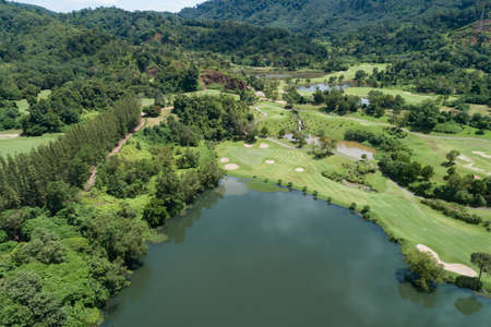 Aerial view drone shot of beautiful green golf field fairway and putting green Top down image for sport background and travel nature background Amazing view at Phuket Thailand.の写真素材