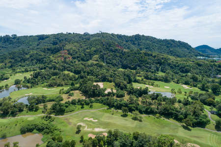Aerial view drone shot of beautiful green golf field fairway and putting green Top down image for sport background and travel nature background Amazing view at Phuket Thailand.の写真素材