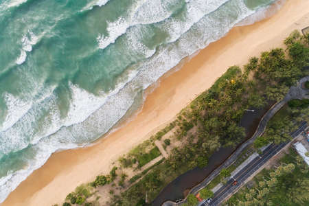 Top view coconut palm trees on the beach Phuket Thailand Sea texture waves Foaming and Splashing on beach Beautiful wave sea surface background.の写真素材