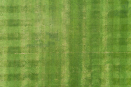 Aerial Top view of Green grass soccer field background.