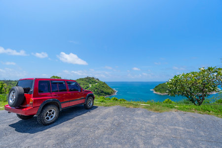 23 September 2021 Red 4x4 car Suzuki Vitara 1993 on the mountain in Phuket Thailand with Summer sea and small island background of free space for summer text and travel transportation background.のeditorial素材