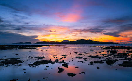 Beautiful sunset or sunrise seascape amazing cloud at sunrise light above the coral reef in Rawai sea Phuket Severe low tide corals growing in the shallows.Staghorn coralの写真素材