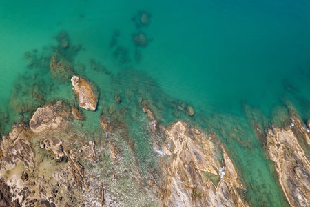 Aerial view Top down seashore rocks sea surface in sunny day Good weather day summer background