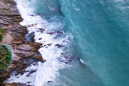 Aerial view Drone camera top down of seashore rocks in a blue ocean Turquoise sea surface Amazing...