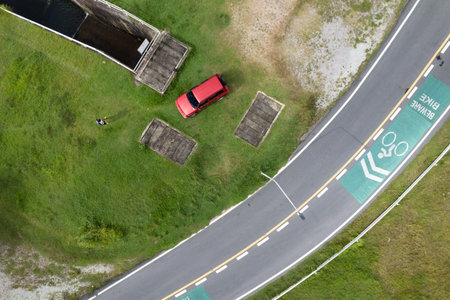 Aerial view photo high angle view top down of red suv car and asphalt curve road