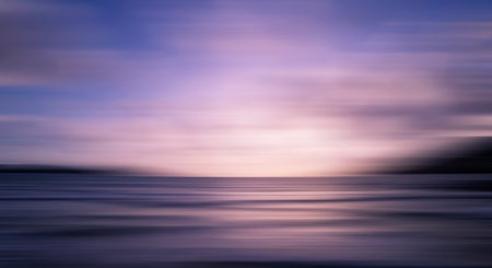 Blurred sea background at sunset, Abstract natural background and texture motion blur,panoramic view of sunrise over ocean.Dark sky sunlight and deep dark water sea backgroundの写真素材
