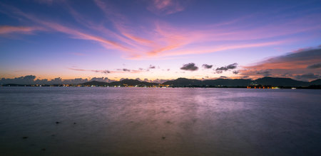 Landscape Long exposure of majestic clouds in the sky sunset or sunrise over sea with reflection in...