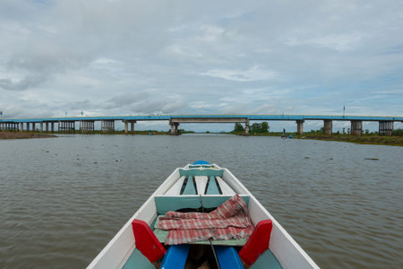 Fishing boat in a lake water in the morning,Old wooden fishing boat, wooden fishing boat in a lake water Beautiful landscape nature view in Talay noi Phatthalung Thailandの写真素材