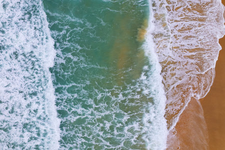 Aerial view of sea crashing waves White foaming waves on beach sand, Top view beach seascape view...