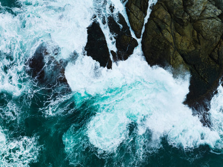 Seashore aerial view,Bird eye view photo of crashing waves on rocks beautiful water surface...