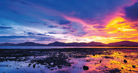 Landscape Long exposure of majestic clouds in the sky sunset or sunrise over sea with reflection in...
