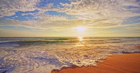 Amazing waves ocean beach in sunrise or sunset light over sea,Beautiful light colorful nature sky and clouds sea backgroundの写真素材