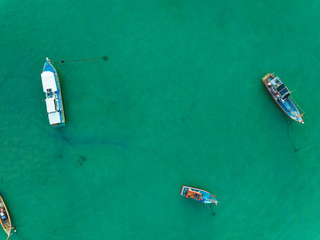 Aerial drone bird's eye view photo Top down of tropical sea with long tail fishing boats Travel boats at phuket thailand, Amazing top view sea nature landscapeの写真素材