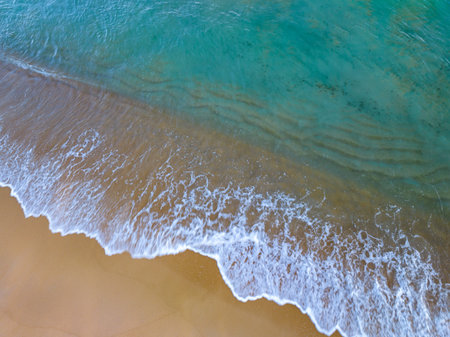 Summer sea nature background,Aerial view of Waves crashing on sandy shore,Sea surface ocean waves...