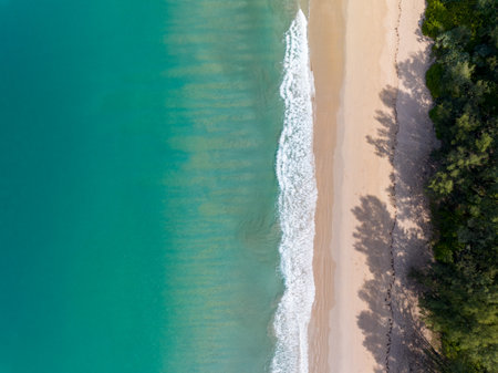 Sea surface aerial view,Bird eye view photo of crashing waves on sandy shore,Beach sea water surface texture,sea sand background,Beautiful nature seascape,Amazing top view beach backgroundの写真素材