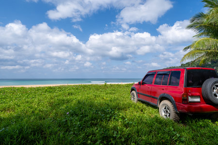 Red SUV 4x4 car on the mountain with Summer sea and blue sky background,Copy space for summer text and travel transportation background.の写真素材