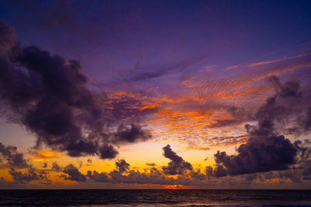 Beautiful colorful sunset or sunrise sky over sea with dramatic clouds nature environment backgroundの写真素材