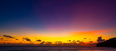 Beautiful colorful sunset or sunrise sky over sea with dramatic clouds nature environment backgroundの写真素材
